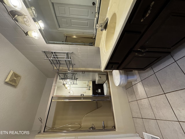 bathroom with tile patterned floors and visible vents