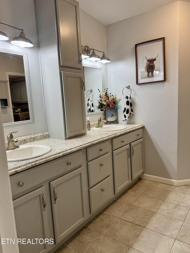 bathroom featuring double vanity, tile patterned flooring, and a sink
