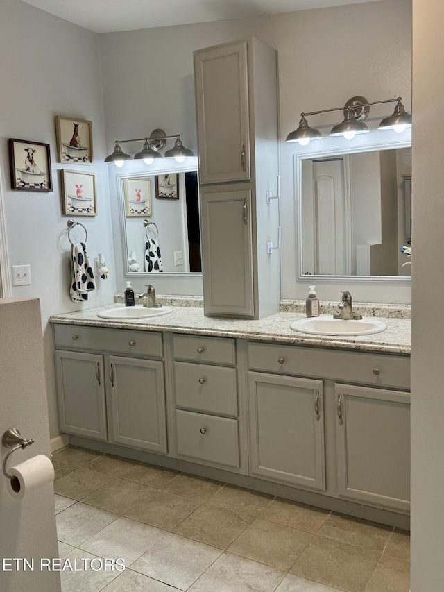 full bathroom with double vanity and a sink