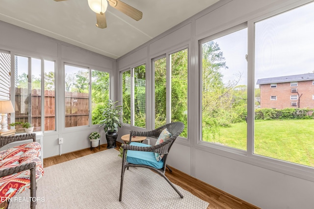 sunroom / solarium with a ceiling fan