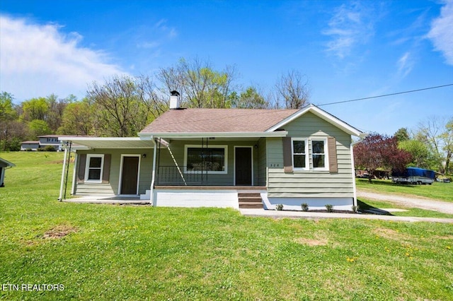 single story home featuring a front yard, a chimney, and covered porch