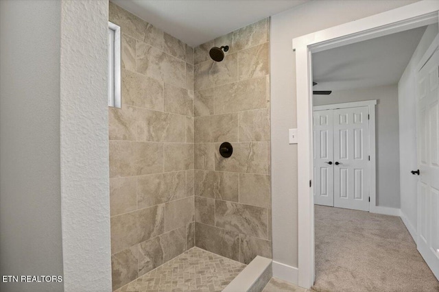 bathroom with a tile shower