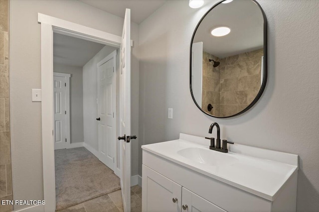 bathroom with tile patterned floors, vanity, and baseboards