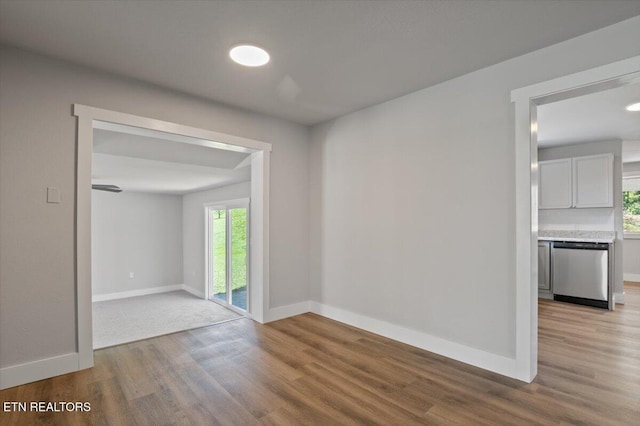 unfurnished room featuring baseboards and wood finished floors