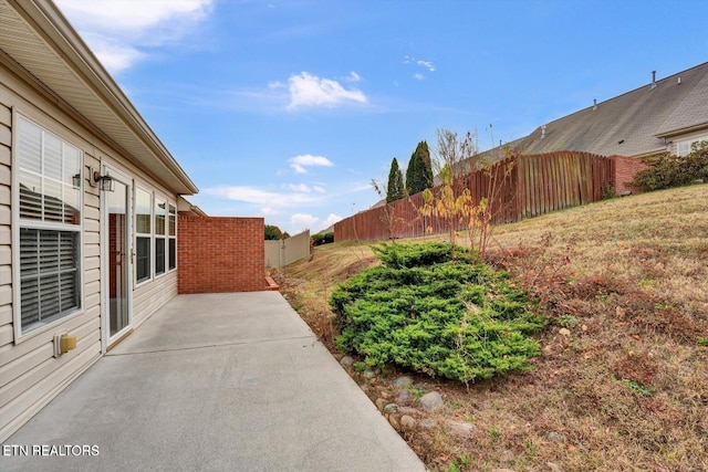 view of yard featuring a patio area and fence