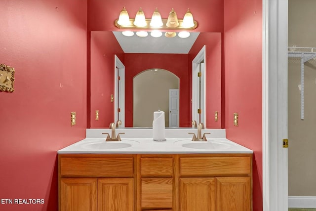 full bath featuring a sink and double vanity