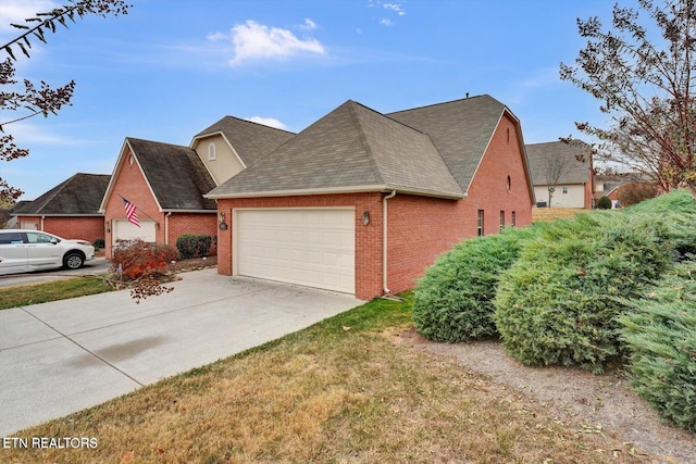 view of front of house featuring brick siding, driveway, a shingled roof, and a garage