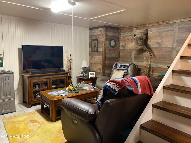 174 Jackson Rd, Caryville, TN 37714 - living area featuring light tile patterned flooring, wooden walls, and stairway