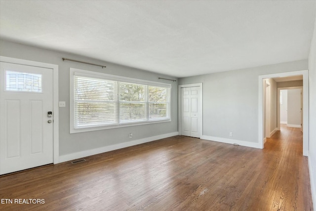 foyer with visible vents, baseboards, and wood finished floors