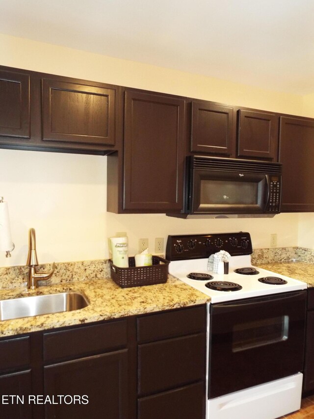 225 Collier Dr, Sevierville, TN 37862 - kitchen featuring black microwave, a sink, range with electric cooktop, and dark brown cabinetry