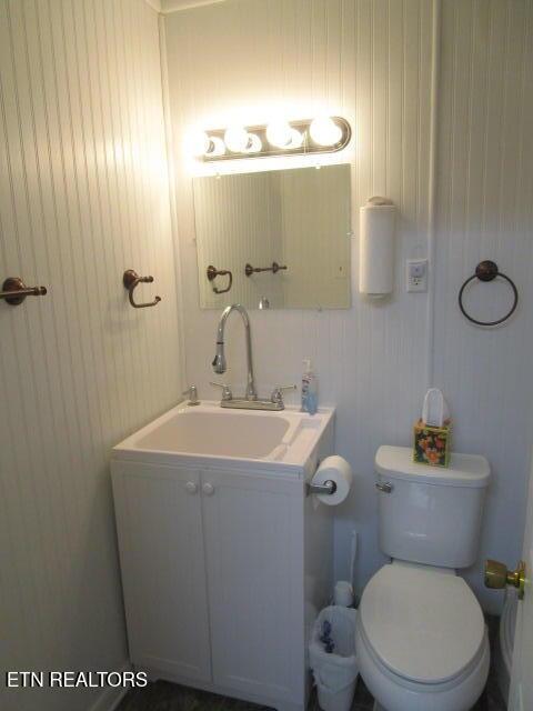 bathroom featuring toilet and vanity