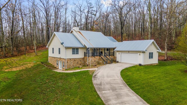 2143 Renegade Mountain Pkwy, Crab Orchard, TN 37723 - ranch-style house featuring a front yard, stairs, an attached garage, a chimney, and driveway