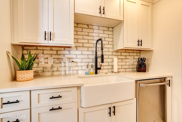 3835 SW Keowee Ave, Knoxville, TN 37919 - kitchen with dishwasher, white cabinetry, a sink, and backsplash