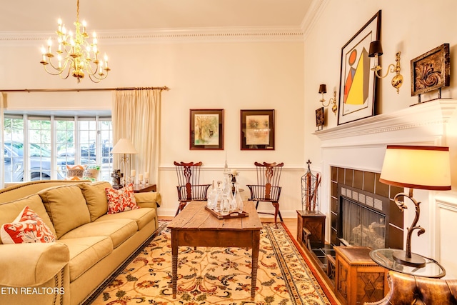3835 SW Keowee Ave, Knoxville, TN 37919 - living room with a tiled fireplace, a notable chandelier, ornamental molding, and wood finished floors