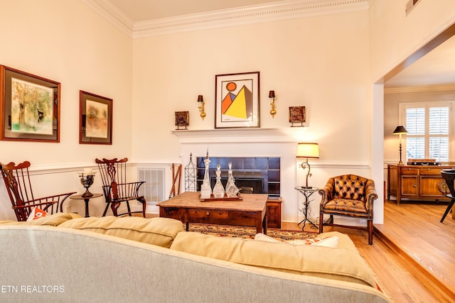 3835 SW Keowee Ave, Knoxville, TN 37919 - living area featuring crown molding, visible vents, light wood-style flooring, and a fireplace