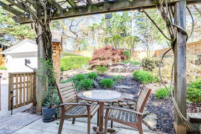 3835 SW Keowee Ave, Knoxville, TN 37919 - view of patio featuring a shed, a pergola, fence, outdoor dining area, and an outbuilding