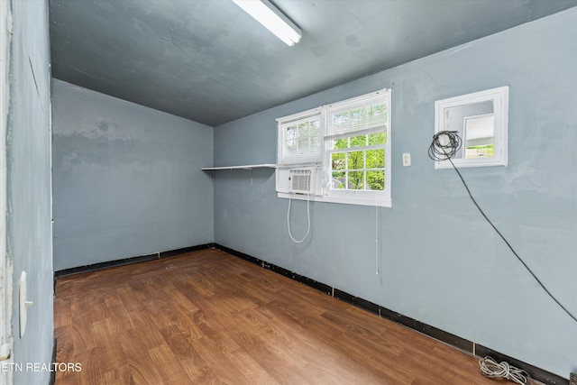 spare room with dark wood-style flooring and baseboards