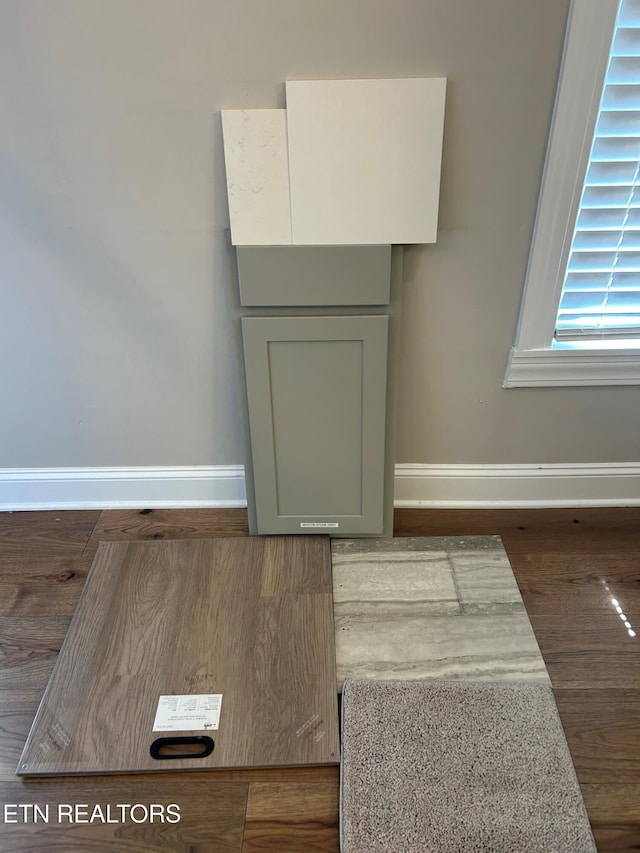 room details with baseboards and wood finished floors