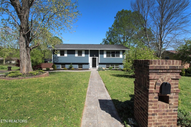 bi-level home with a front lawn and a shingled roof