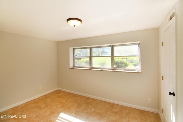 unfurnished room with visible vents, baseboards, and light tile patterned floors