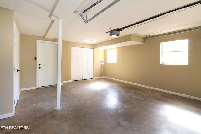 garage with baseboards and a garage door opener