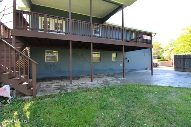 back of property featuring a patio, a lawn, concrete block siding, and stairway