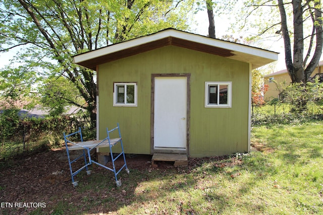 view of outbuilding with an outdoor structure and fence