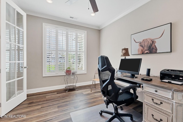 office space featuring baseboards, ornamental molding, dark wood-style floors, visible vents, and ceiling fan