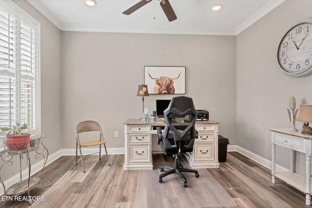 office space with ornamental molding, baseboards, a ceiling fan, and wood finished floors