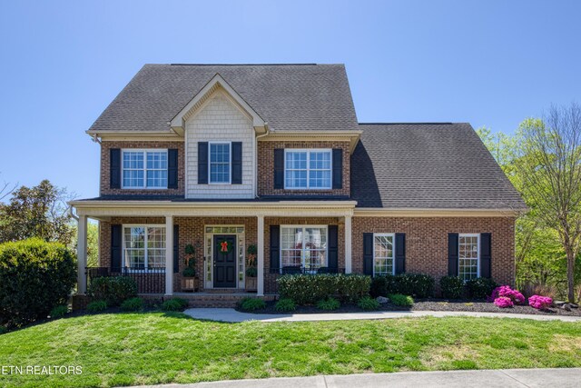 2021 Willow View Ln, Knoxville, TN 37922 - view of front of property featuring roof with shingles, a front yard, a porch, and brick siding