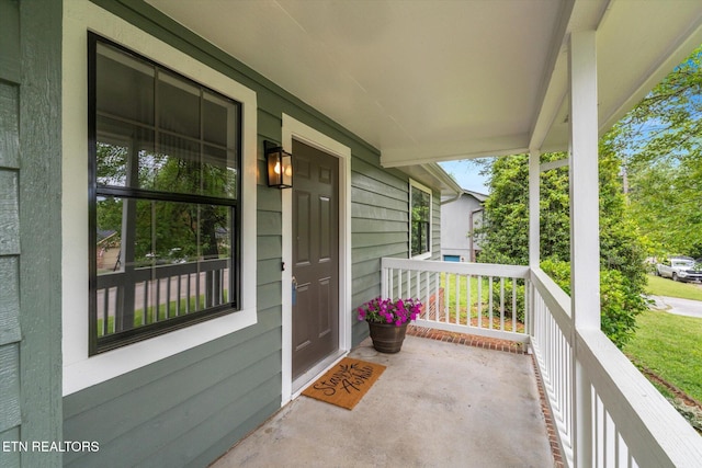 view of exterior entry featuring a porch