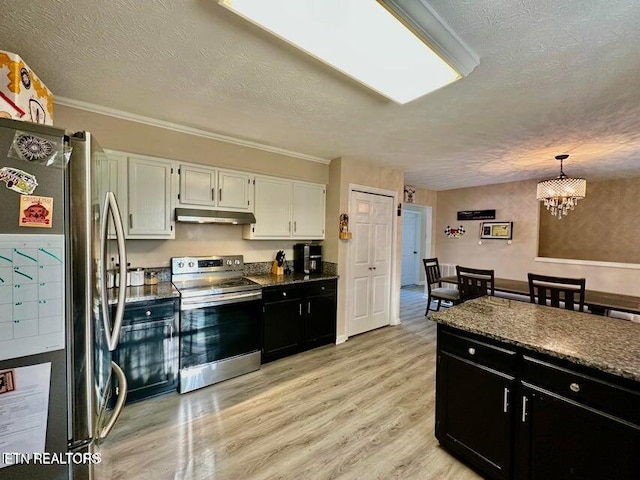 kitchen with white cabinets, under cabinet range hood, dark cabinets, and stainless steel appliances