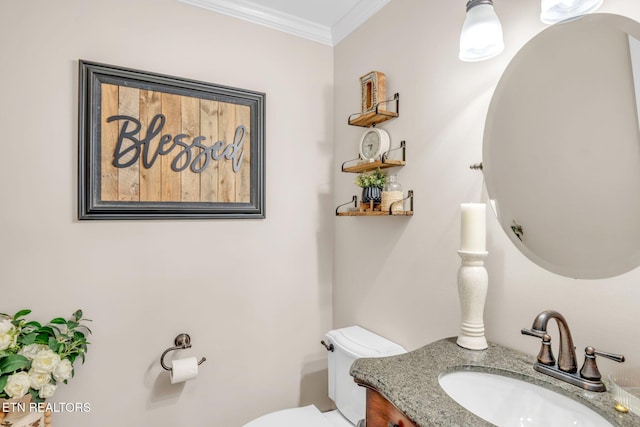 bathroom featuring crown molding, toilet, and vanity