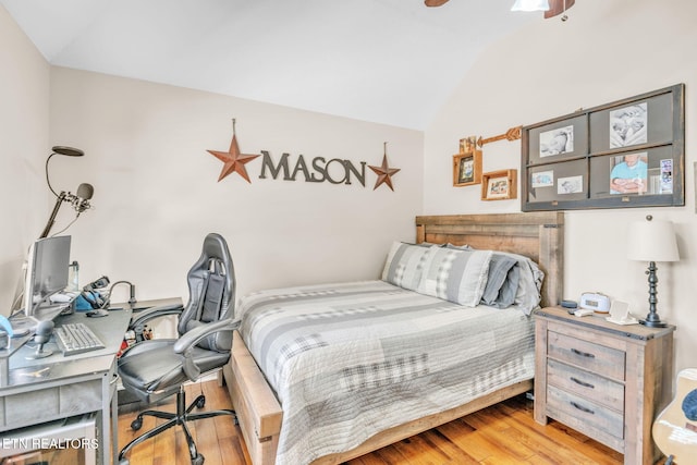 bedroom with wood finished floors, ceiling fan, and lofted ceiling