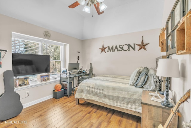 bedroom featuring baseboards, a ceiling fan, vaulted ceiling, and hardwood / wood-style flooring
