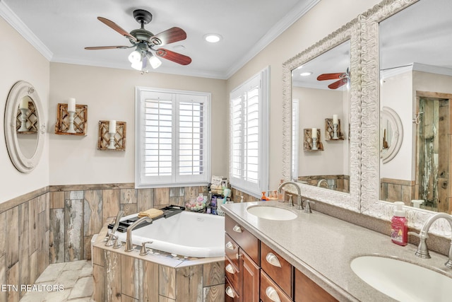 full bath featuring a garden tub, a sink, ornamental molding, and ceiling fan