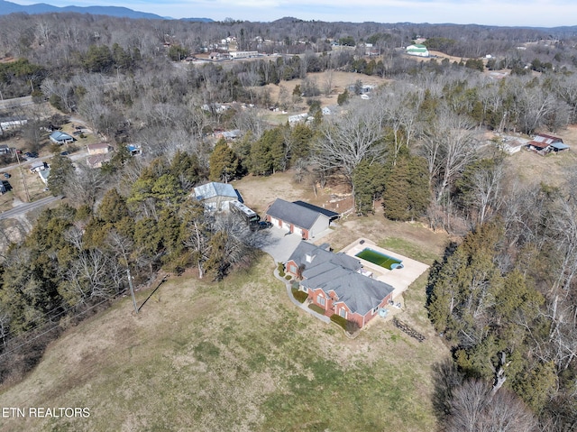 bird's eye view featuring a wooded view