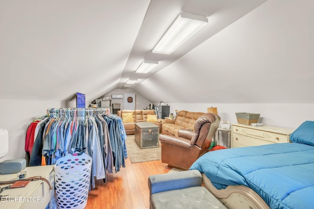 bedroom featuring wood finished floors and vaulted ceiling