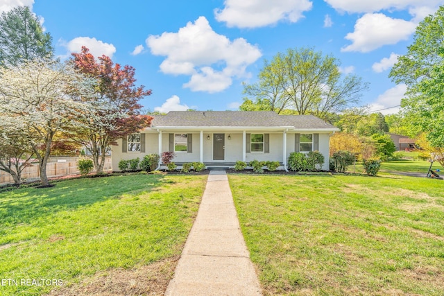 view of front of property with a front lawn and fence