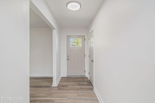 interior space featuring baseboards and wood finished floors