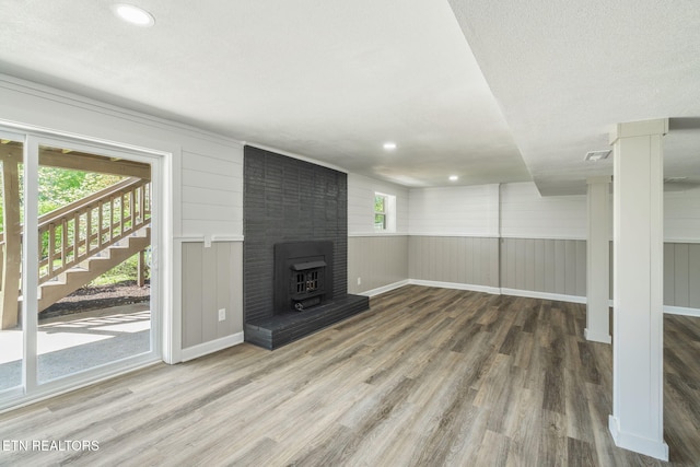 below grade area with visible vents, recessed lighting, stairway, wood finished floors, and baseboards