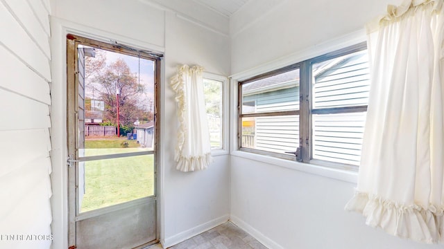 entryway with baseboards and a wealth of natural light
