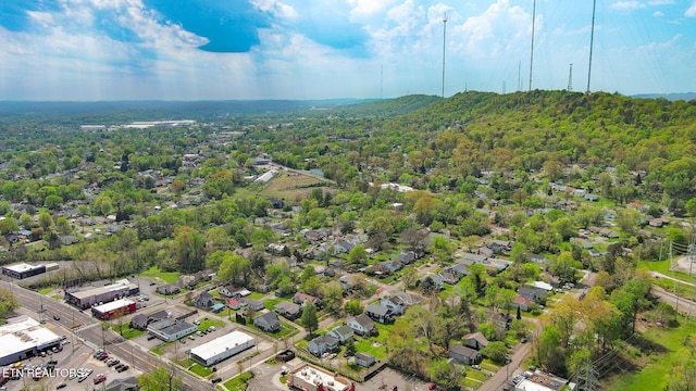 birds eye view of property featuring a wooded view
