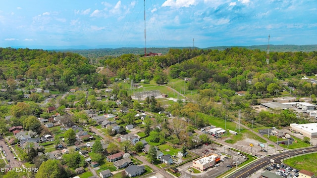 drone / aerial view featuring a wooded view