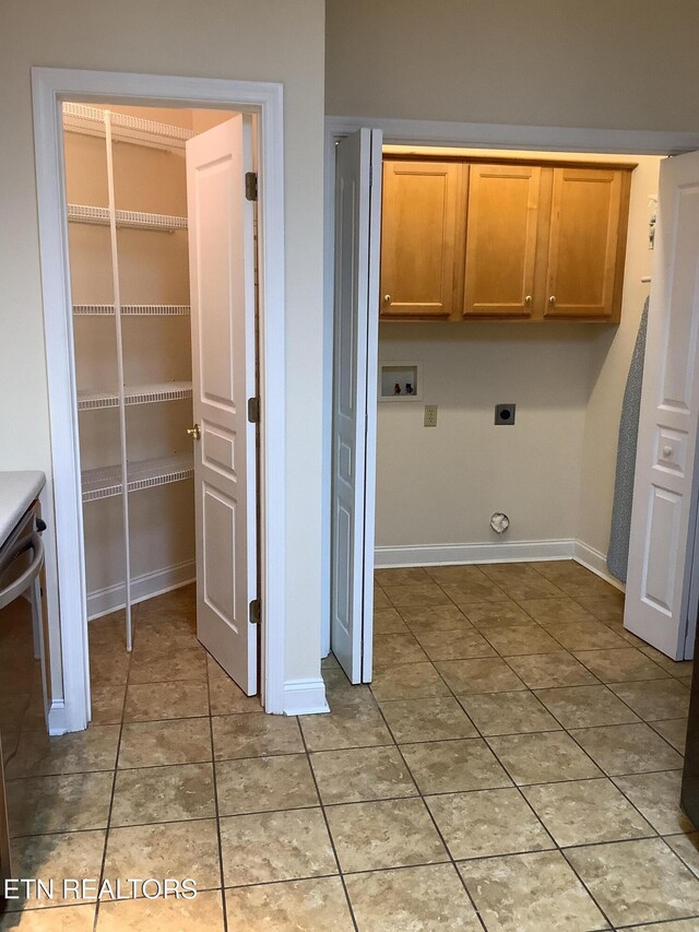 11608 San Martin Ln, Knoxville, TN 37934 - laundry area with cabinet space, washer hookup, electric dryer hookup, baseboards, and light tile patterned flooring