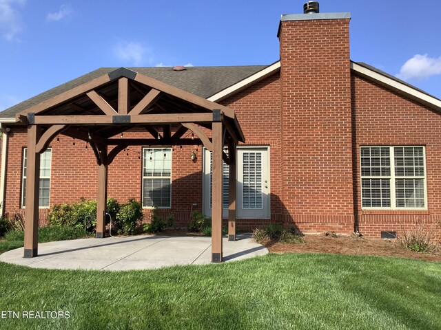 11608 San Martin Ln, Knoxville, TN 37934 - rear view of property with a chimney, a lawn, brick siding, a patio, and a shingled roof