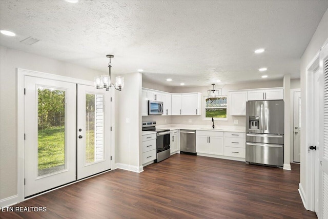 kitchen featuring light countertops, a sink, dark wood-style floors, and stainless steel appliances