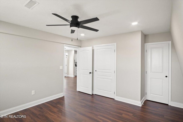 unfurnished bedroom featuring visible vents, baseboards, and dark wood finished floors