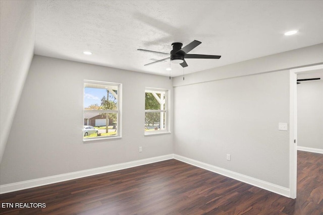 spare room featuring dark wood-style flooring, baseboards, recessed lighting, a textured ceiling, and ceiling fan