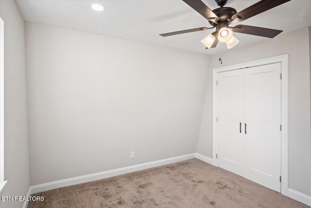 unfurnished bedroom with carpet floors, baseboards, recessed lighting, and a closet
